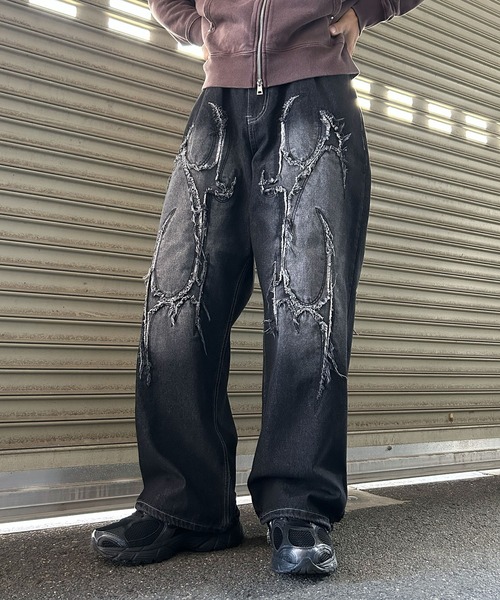 NYLAUS(ナイラス)の「【NYS】トライバル カットオフモチーフ バギーパンツ ワイドデニムパンツ(デニムパンツ・メンズ・ブラック/ブルー・M/L)」の1枚目の写真