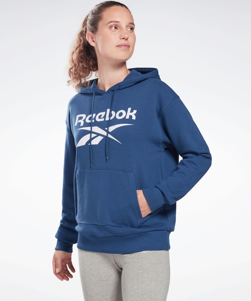 Reebok(リーボック)の「 アイデンティティ ロゴ フレンチテリー フーディー / Identity Logo French Terry Hoodie(パーカー・レディース・ヘザーグレー/ブルー/ホワイト×ブラック/ライトグレー/コーラルピンク/グレー×ホワイト/ピンク系その他/ブラック・SMALL/MEDIUM/LARGE/X-LARGE/X-SMALL)」の1枚目の写真