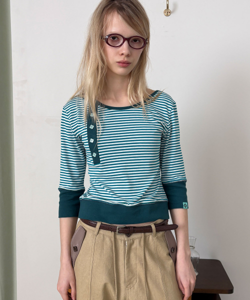 HERETIC(ヘレティック)の「BUTTON STRIPE ASYM HENLEY T-SHIRT / blue green(Tシャツ/カットソー・レディース・その他・FREE)」の1枚目の写真
